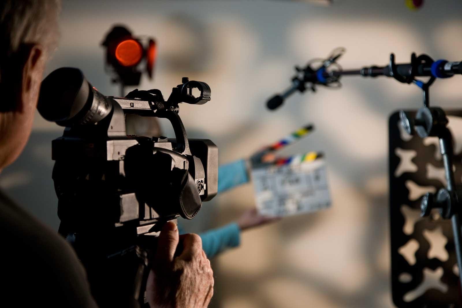 video production marketing strategy - man holding a camera and ready for shooting 
